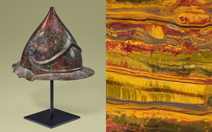 A bronze helmet is displayed on the left, and a colorful stone pattern is on the right.