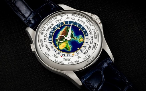 A luxury world time watch with a colorful map dial and names of global cities around the edge.