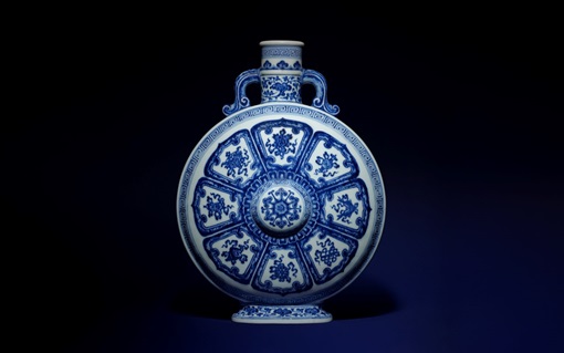 A round blue and white porcelain vase with intricate floral and geometric patterns.