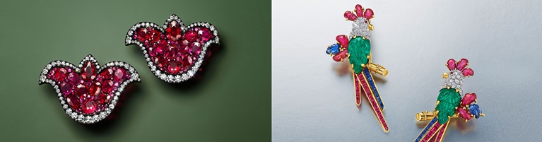 The image shows two pairs of ornate earrings: one with red gemstones and diamonds, and another shaped like colorful parrots.