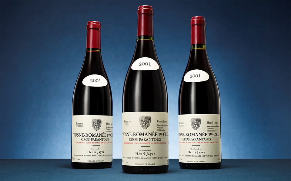 Three bottles of Henri Jayer Vosne-Romanée 1er Cru Cros-Parantoux 2001 wine are displayed.