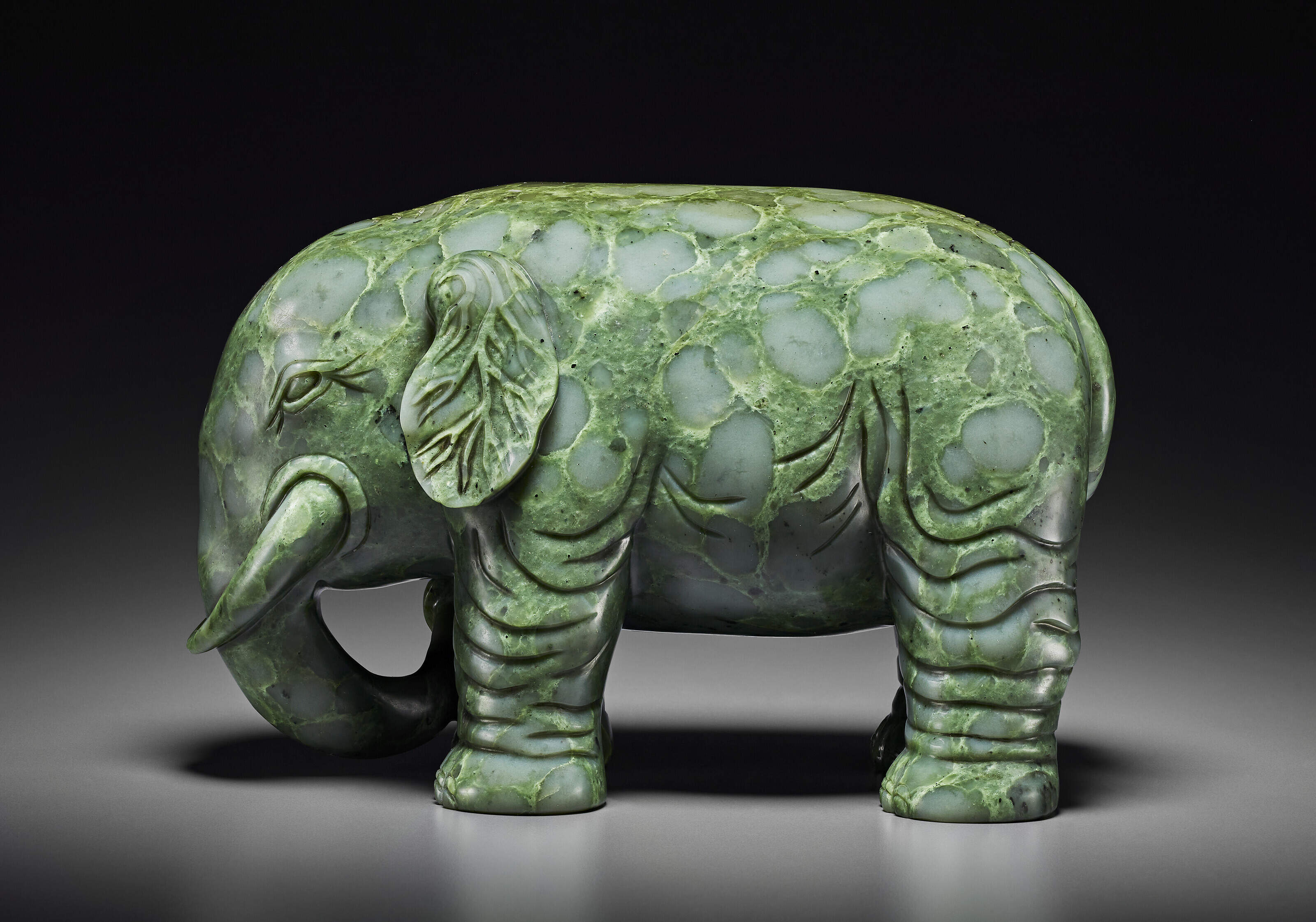 A SUPERB LARGE SPINACH-GREEN JADE FIGURE OF AN ELEPHANT, QIANLONG
